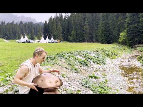 Playing Handpan by the Tipis in the Rain